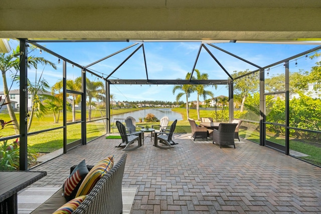 view of patio / terrace with a water view and a lanai