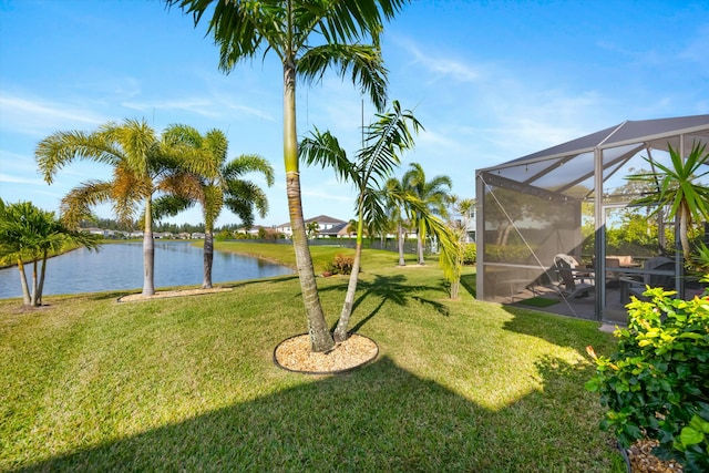 view of yard with a water view and a lanai