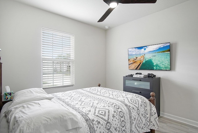 bedroom with ceiling fan and light hardwood / wood-style flooring