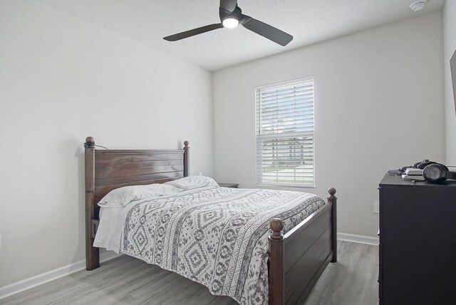 bedroom with ceiling fan and light hardwood / wood-style flooring