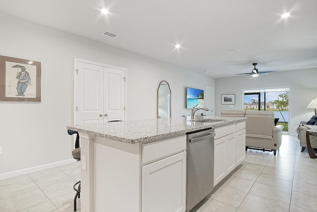 kitchen featuring sink, a center island with sink, white cabinets, light tile patterned flooring, and stainless steel dishwasher