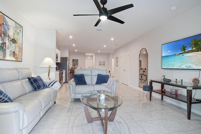 tiled living room featuring ceiling fan