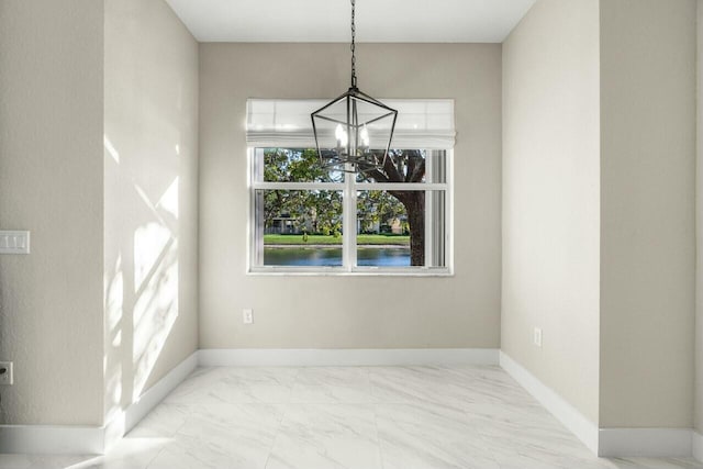 unfurnished dining area featuring an inviting chandelier and a water view