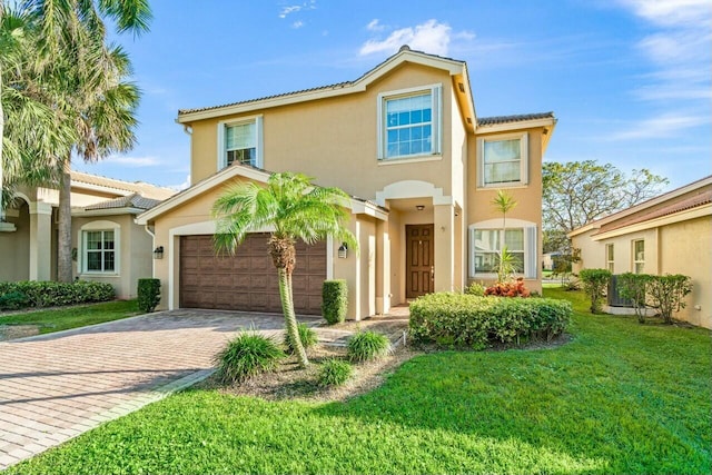 mediterranean / spanish-style home featuring a garage and a front lawn