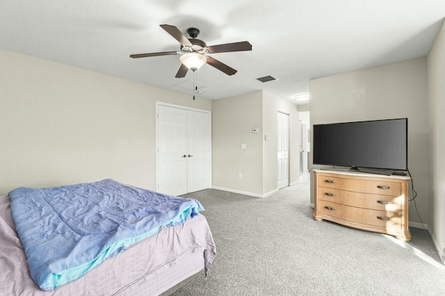 carpeted bedroom featuring a closet and ceiling fan