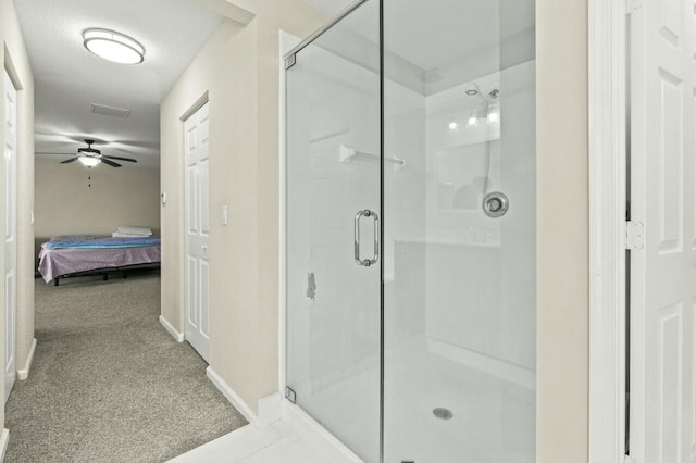 bathroom featuring a shower with door