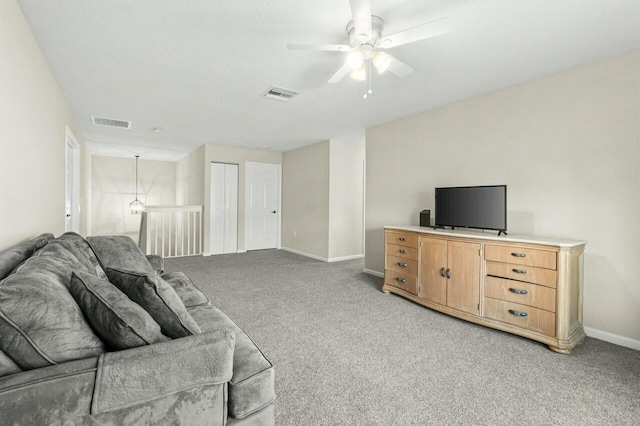 carpeted living room featuring ceiling fan