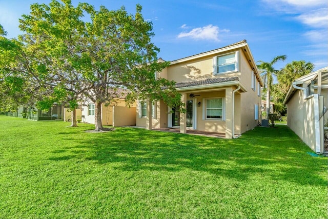 back of house with a yard and a patio area