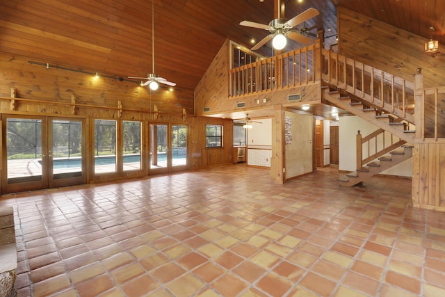 unfurnished living room with french doors, wood ceiling, and wood walls