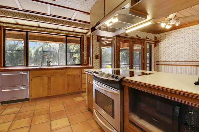 kitchen featuring french doors, sink, exhaust hood, and electric range