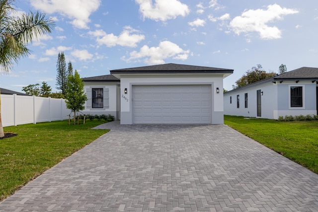 view of front of house featuring a garage and a front lawn