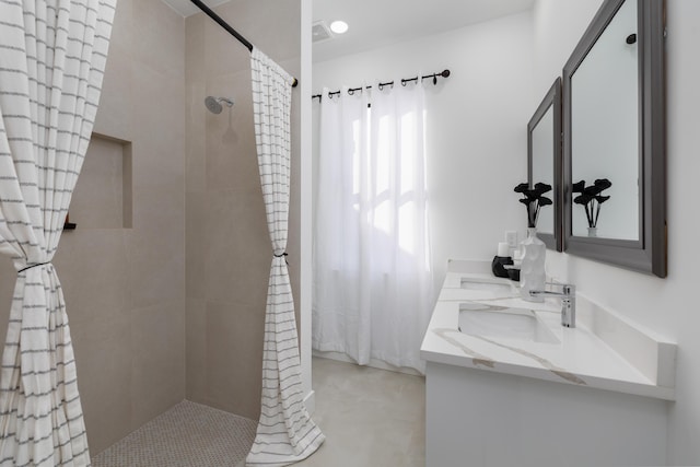 bathroom featuring vanity and curtained shower