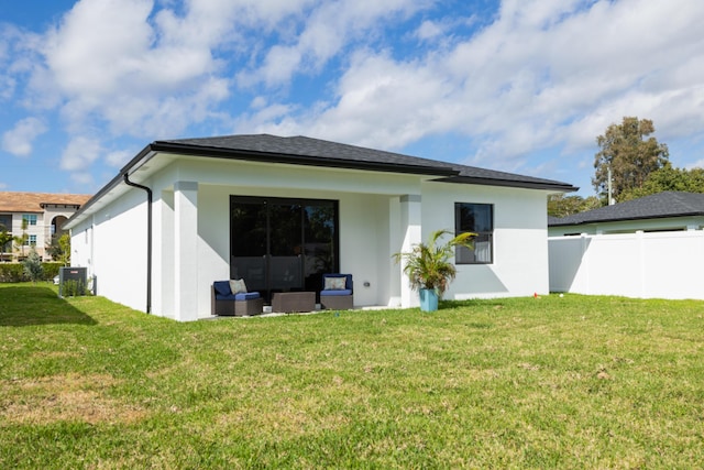 rear view of property featuring cooling unit, a lawn, and outdoor lounge area