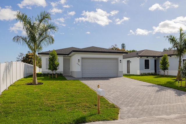 view of front of home with a garage and a front yard