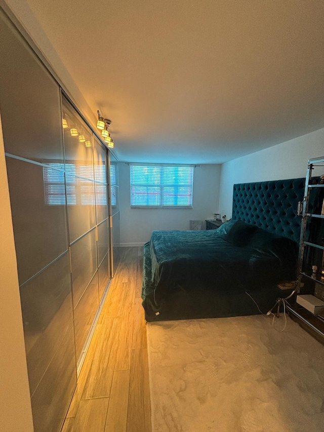 bedroom with wood-type flooring