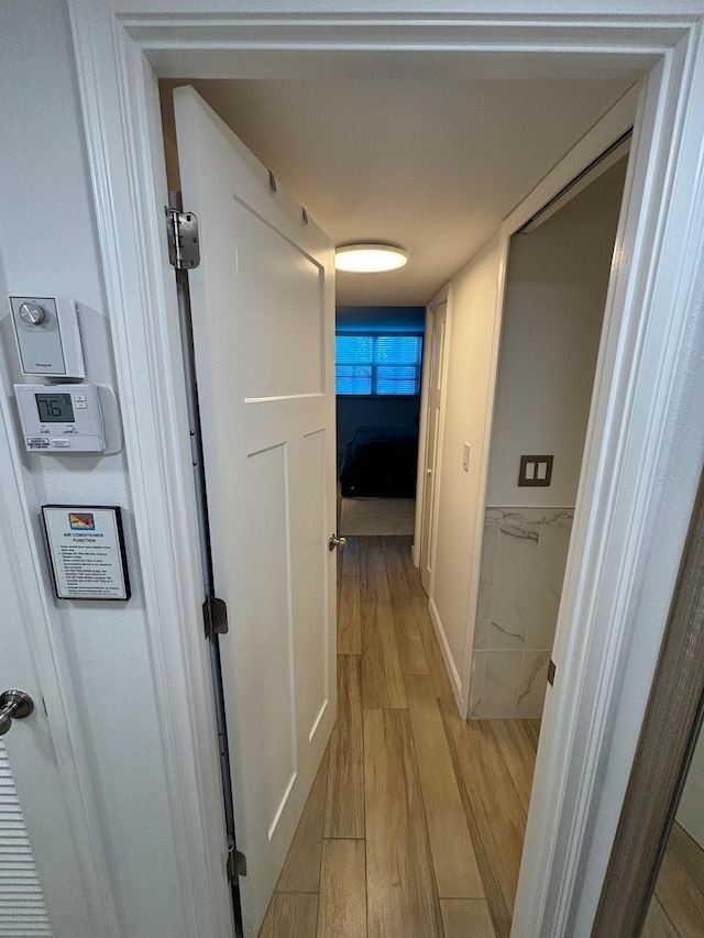 hallway with light wood-type flooring