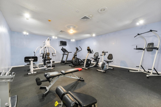 exercise room with a textured ceiling