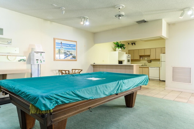 recreation room featuring light tile patterned floors, pool table, sink, and a textured ceiling