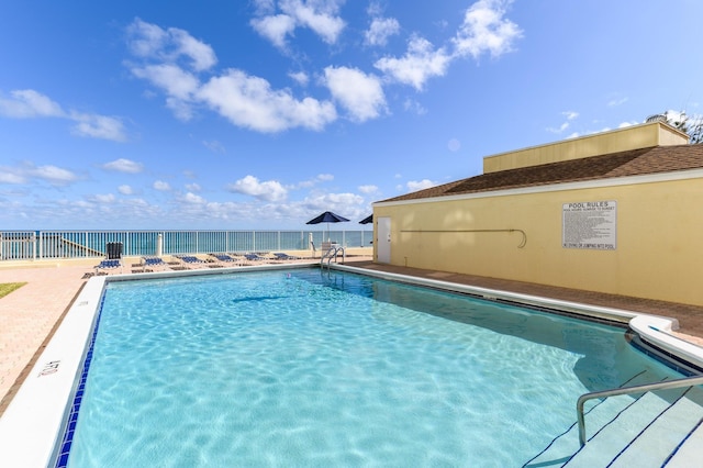 view of pool with a water view