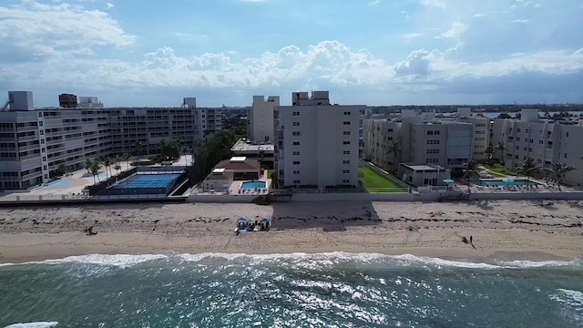 drone / aerial view with a beach view and a water view