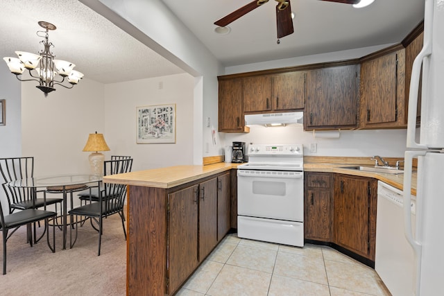 kitchen featuring sink, decorative light fixtures, light tile patterned floors, kitchen peninsula, and white appliances