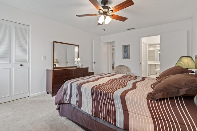 carpeted bedroom featuring ceiling fan, a textured ceiling, and ensuite bathroom