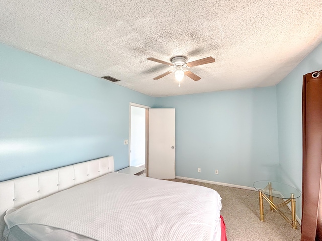 bedroom featuring a textured ceiling, ceiling fan, and carpet flooring