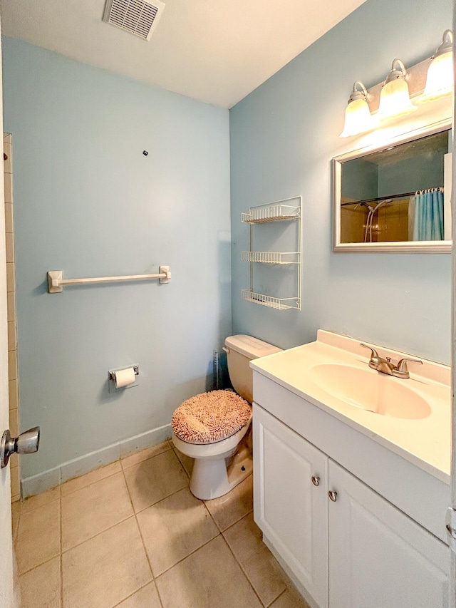 bathroom with walk in shower, tile patterned floors, toilet, and vanity