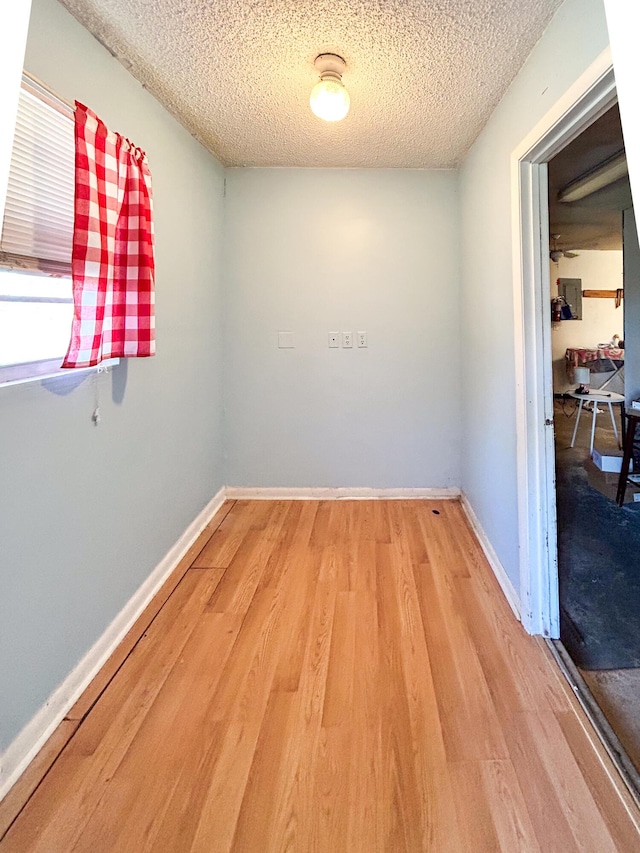 spare room featuring a textured ceiling and light wood-type flooring