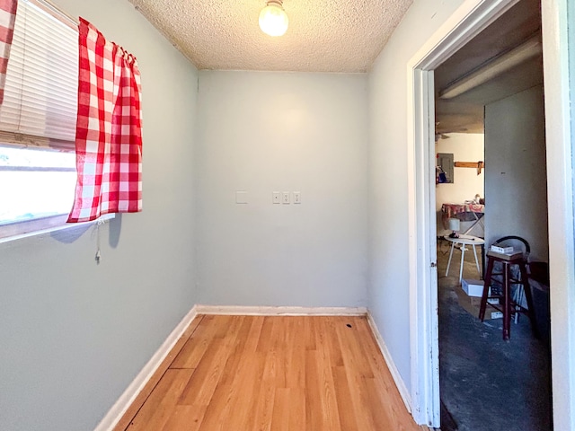 interior space featuring hardwood / wood-style flooring and a textured ceiling