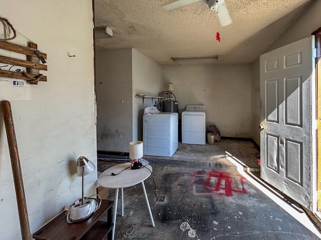 washroom with ceiling fan, washing machine and dryer, water heater, and a textured ceiling