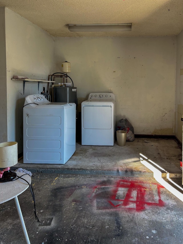 laundry area with independent washer and dryer, water heater, and a textured ceiling