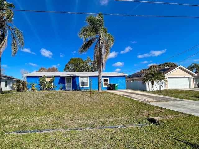 ranch-style home with a garage and a front lawn