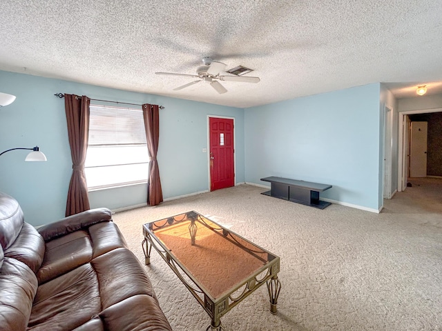 living room featuring a textured ceiling, carpet floors, and ceiling fan