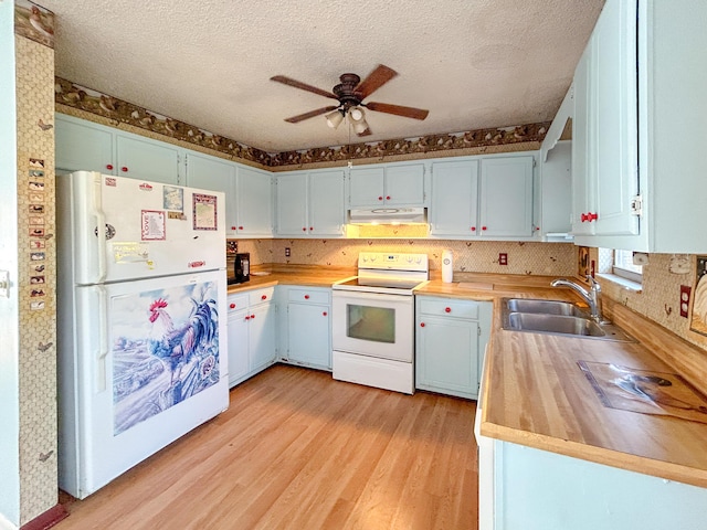 kitchen with sink, white appliances, ceiling fan, butcher block counters, and light wood-type flooring