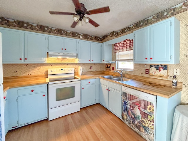 kitchen with butcher block countertops, sink, white appliances, and light wood-type flooring