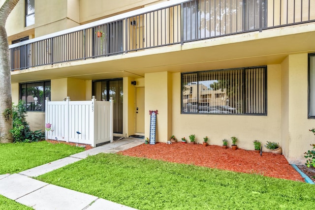 view of exterior entry featuring a yard