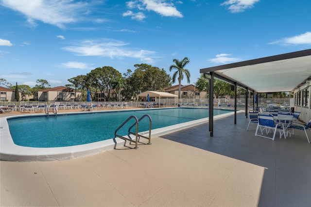 pool with fence and a patio