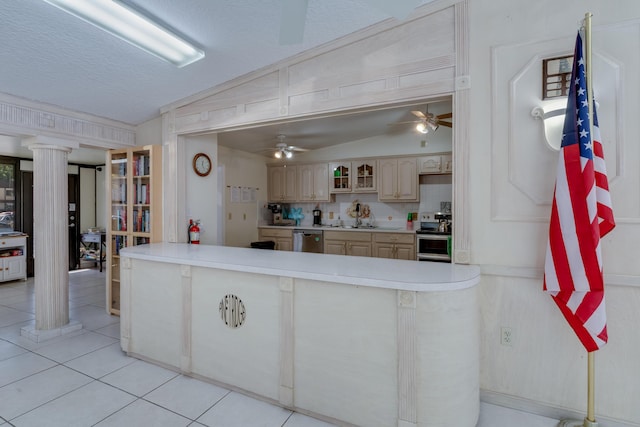 kitchen with glass insert cabinets, light tile patterned floors, appliances with stainless steel finishes, and vaulted ceiling