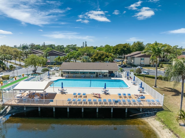 exterior space with a water view, fence, and a patio