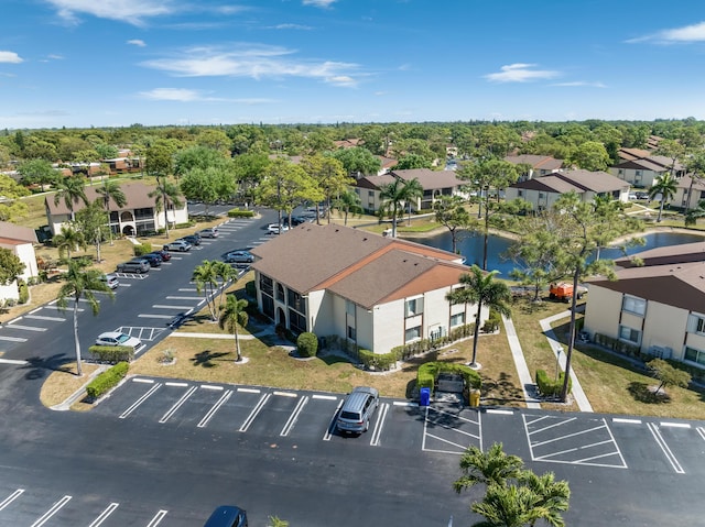 bird's eye view with a water view and a residential view