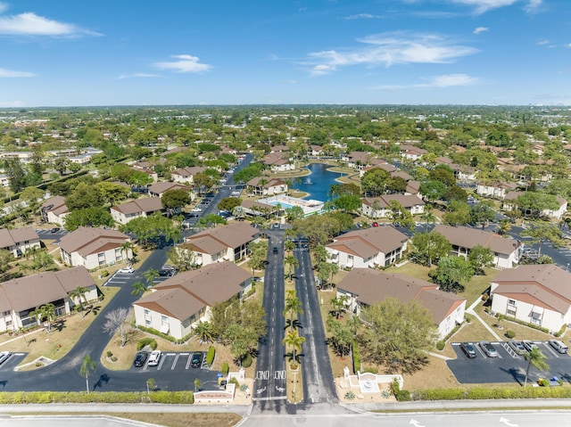 drone / aerial view with a water view and a residential view