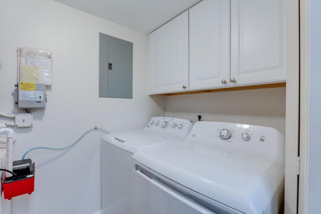 laundry area with washing machine and dryer, electric panel, and cabinet space