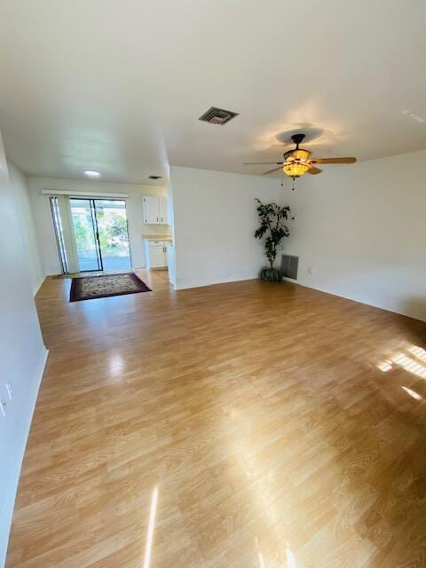 spare room featuring light hardwood / wood-style floors and ceiling fan