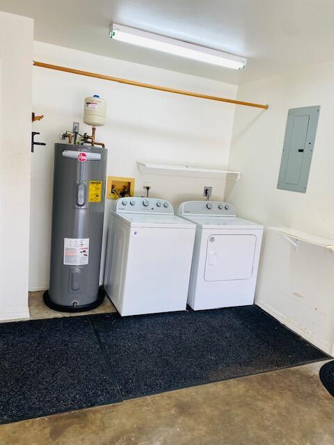 laundry room featuring electric water heater, electric panel, and independent washer and dryer