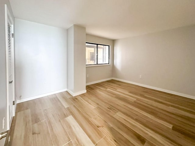 unfurnished room with light hardwood / wood-style flooring