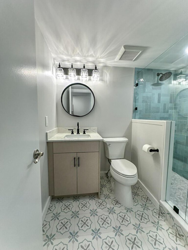 bathroom with vanity, toilet, and a shower with shower door