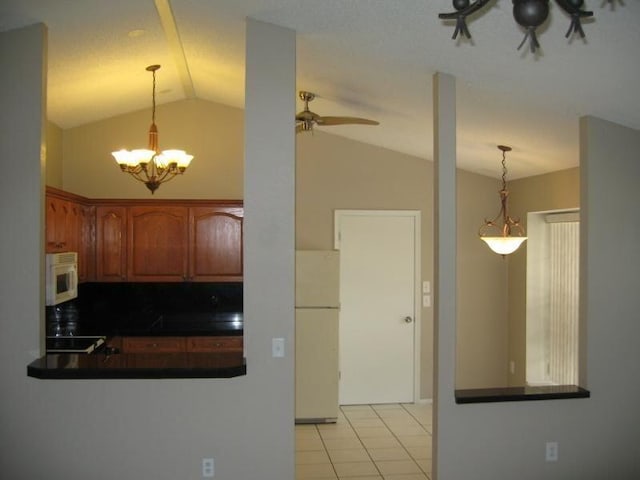 kitchen featuring decorative backsplash, white appliances, vaulted ceiling, and hanging light fixtures