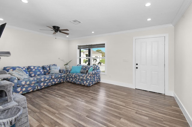 living room with ornamental molding, wood-type flooring, and ceiling fan