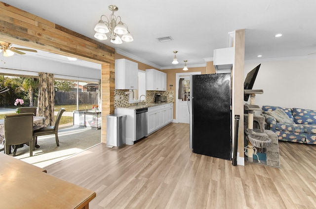 kitchen featuring sink, white cabinetry, light hardwood / wood-style flooring, appliances with stainless steel finishes, and backsplash